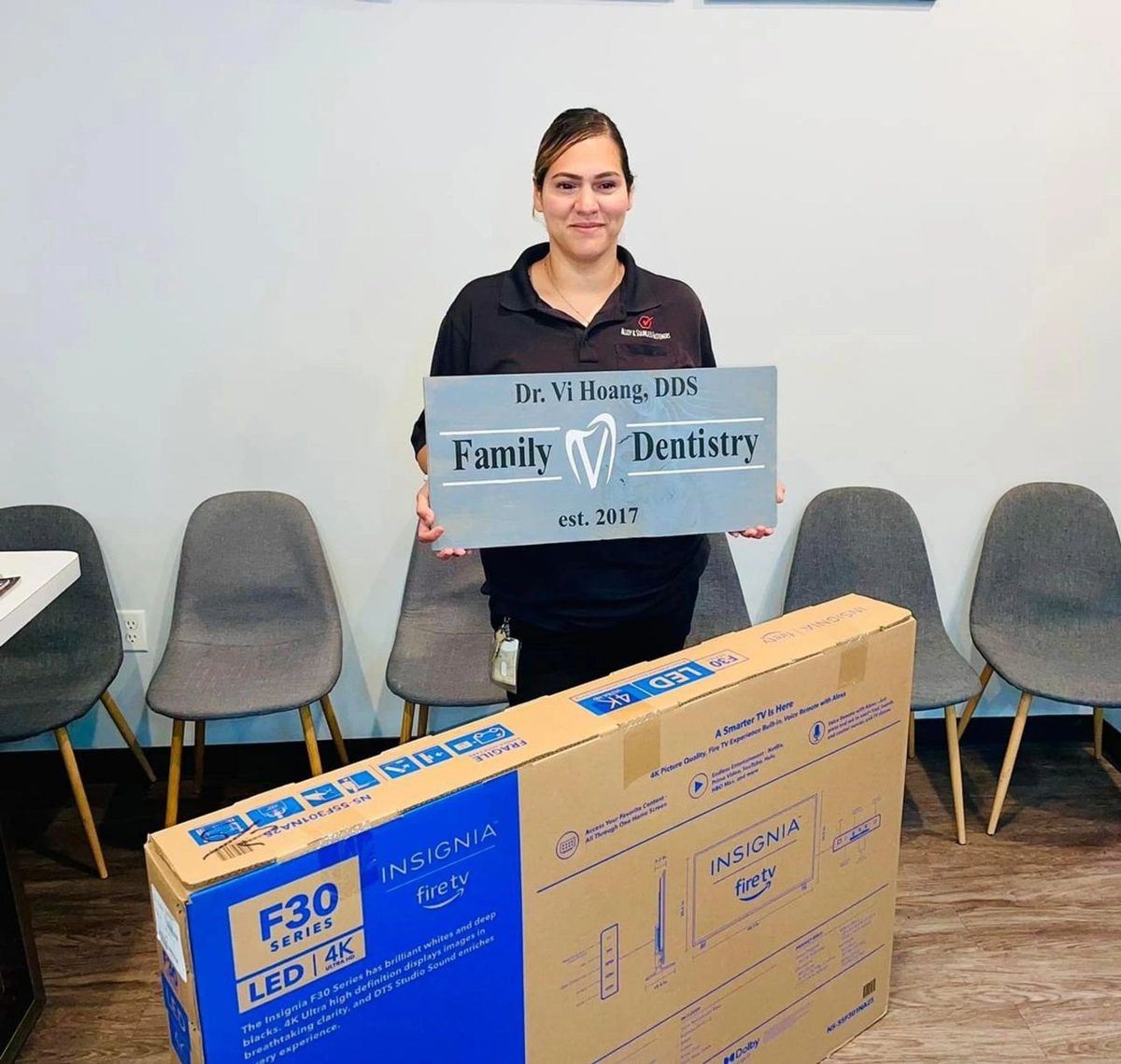 A V Family Dentistry patient raffle winner with a new TV